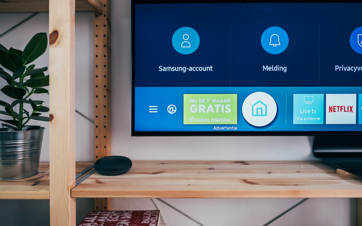 Samsung smart TV home screen on a shelf