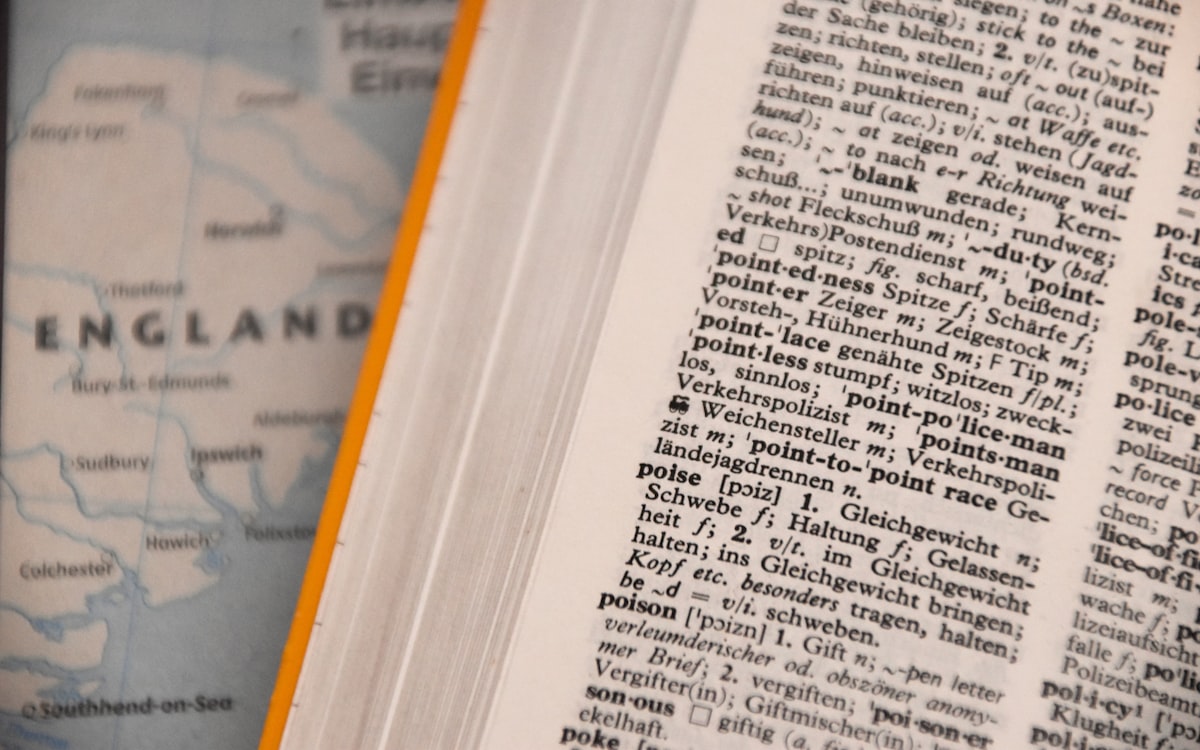Bilingual dictionary open beside a map